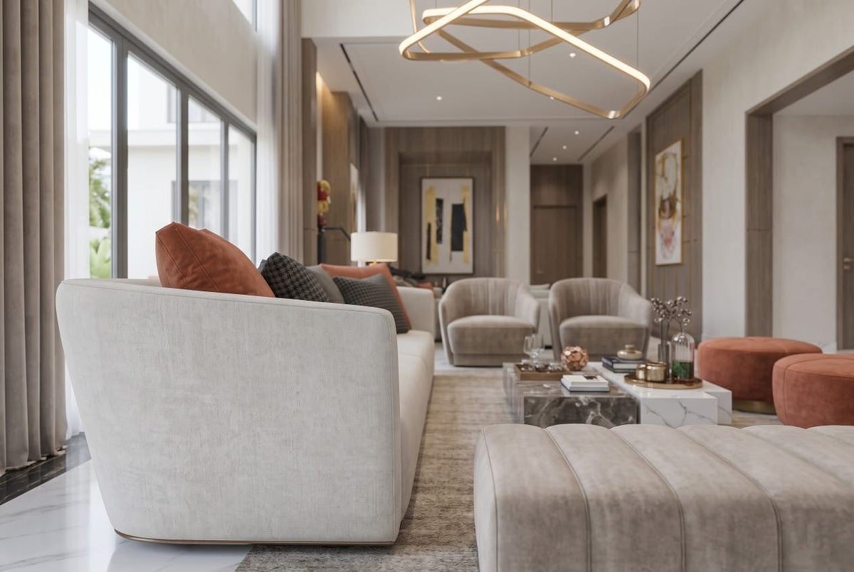 Curved ivory sofa with terracotta and grey cushions, velvet armchairs beyond